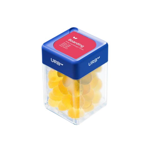 A clear container with a blue lid, labeled "Urb" and featuring a red label that reads "Boarding Skybites Delta 9 Gummies," holds a stack of orange gummies.