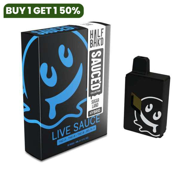 A black box labeled "Half Bak'd" Half Bak'd Live Resin Sauced Disposable | 4g. Next to the box is a black disposable vape device with a white smiley face design matching the one on the box. The device features THC-A live resin from the Half Bak'd Live Resin Sauced Collection.