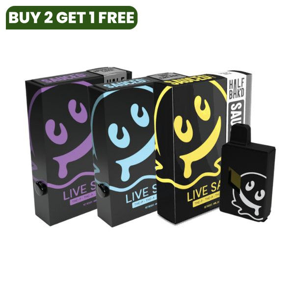 Three colorful boxes and a black device with a cartoon ghost design on them. The text on the boxes reads "Live Sauce" and "Half Saked." These items, part of the Half Bak'd Collection, appear to be THC-A live resin disposable vape products.