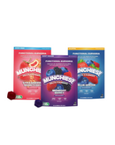Three colorful bags of Delta Munchies Euphoria Delta 9 Gummies—Strawberry Shortcake, Midnight Berry, and Blue Dream—stand upright with gummies in front, made from US grown hemp and Farm Bill compliant for peace of mind.