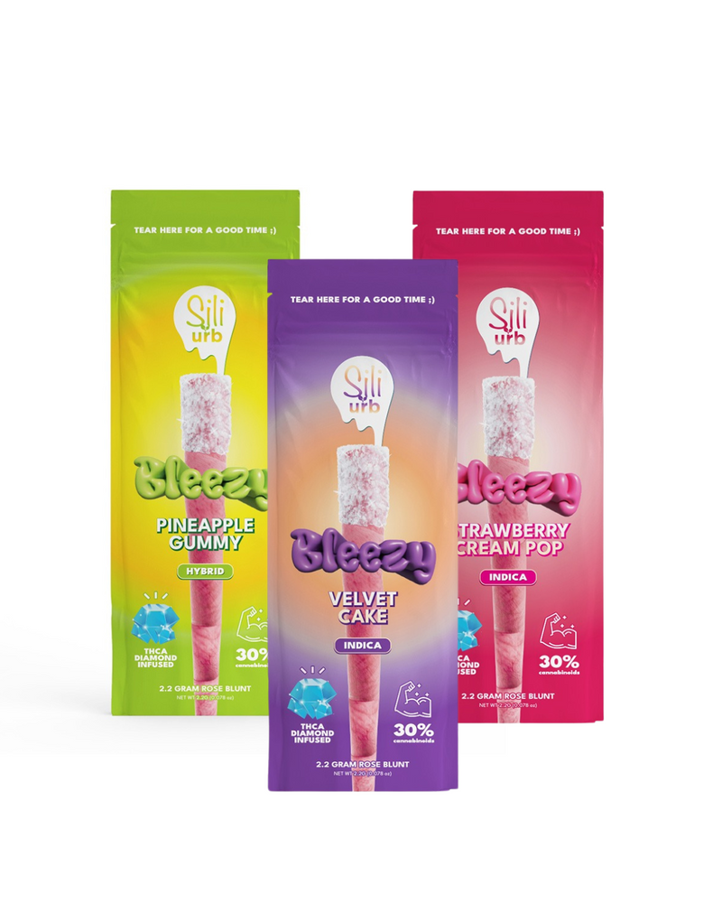 Three packs of Sili x Urb Bleezy THCA Snow Capped Preroll provide vibrant cannabis flavors in Pineapple Gummy, Velvet Cake, and Strawberry Cream Pop, each featuring a hint of D8 THCA THCH fusion and standing upright with eye-catching labels.