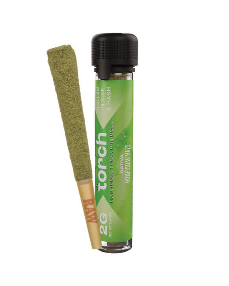 A premium Torch Hashhole THCA Pre-Roll | 2g is encased in a transparent tube labeled "Torch," showcasing its green haze and enhanced potency from being meticulously hand-dipped in hash.