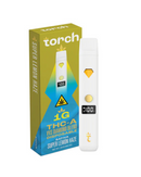 The Torch THC-A VVS Diamond Blend Disposable, 1g, with its sleek design, has bold text and geometric graphics on the box. Featuring "Super Lemon Haze," it offers a premium vaping experience enhanced by the THCA VVS Diamond formulation.